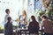 Lets shake on it. colleagues shaking hands during a meeting at an outdoor cafe.