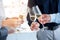 Lets toast to success. Shot of a group of unrecognizable people toasting with wine glasses.