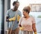 Lets turn chores into something fun. Shot of a young couple singing while cleaning at home.