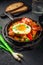 Letscho - tasty Hungarian vegetable stew with peppers, tomatoes and onions, served with bacon and fried egg