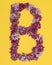 The letter B is lined with lilac flowers on a yellow background. For lettering, composing words.