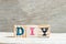 Letter block in word DIY abbreviation of do it yourself on wood background