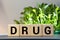 Letter block in word drug on wood background