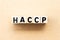 Letter block in word HACCP Hazard Analysis Critical Control Points on wood background