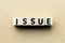 Letter block in word issue on wood background