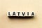 Letter block in word latvia on wood background