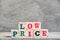 Letter block in word low price on wood background