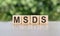 Letter block in word MSDS Abbreviation of material safety data sheet on gray-green background