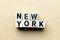 Letter block in word New York on wood background