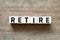 Letter block in word retire on wood background