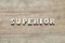 Letter block in word superior on wood background