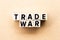 Letter block in word trade war on wood background