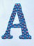 The letter A is blue with red spots, made of plasticine, handmade.