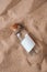 Letter in a bottle on the beach. Island lifestyle. Paper Message in a glass bottle with a cork on the sand. Note on