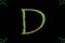 Letter D typed with wild font in green having red outer glow