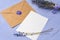 Letter envelope on lavender wooden background, copy space