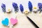 Letter, hearts, pen and delicate flowers on white wooden background