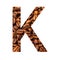 Letter K made from coffee beans isolated on white background