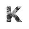 Letter K of monochrome black and white tinsel and paper cut. Festive English alphabet for minimalistic design