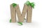 Letter m from the alphabet made of sand with palm trees for summer vacation