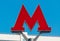 Letter M-symbol of underground transport against the sky - metro