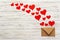 Letter to Valentine Day. Love letter envelope with red hearts on wooden background
