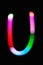 Letter U. Glowing letters on dark background. Abstract light painting at night. Creative artistic colorful bokeh. New Year.