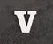 Letter V from blank alphabet on gray background - Top view
