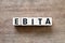 Letter in word EBITA abbreviation of earnings before interest, taxes and amortizationon wood background