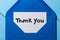 Letter with the words thank you at blue envelope