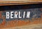 Lettering BERLIN on rusty side wall of a freight forwarder