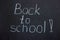 Lettering on the chalk board `back to school`