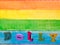 Lettering dolly on wood vintage plank background in lgbt flag colors