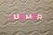 Lettering summer of paper pink letters on sea sand. Summer. relaxation. vacation. top view