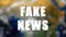 Letters of Fake news text on background with rotating earth, 3d render background, computer generating for news