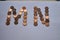 Letters m n of copper coins insulated on a white sheet of paper.