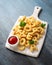 Letters potato fries snack with ketchup on white board. party food