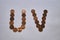 Letters u v of copper coins insulated on a white sheet of paper.