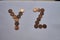 Letters y z of copper coins insulated on a white sheet of paper.