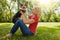 Letting her dog know just how much she loves him. a young woman bonding with her dog in the park.