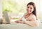 Letting loose at home after a long day. Portrait of a cheerful young woman relaxing on the sofa and using her laptop at