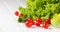 Lettuce salad, tomatoes and green onion on white background