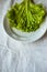 Lettuces leaves on white plate on white background