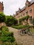 Leuven cosy yard of red brick houses, green bushes and bikes