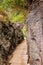 Levada path through great rocks, Madeira