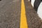 Level asphalted road with dividing yellow stripes. The texture of the tarmac, top view-asphalt with a distinct yellow stripe