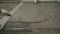 Leveling the floor of a large construction spatula. The worker pours the floors with mortar. The builder is working on