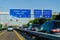 Leverkusen, Germany - July 26, 2019: Road traffic on the German Highway autobahn A1 with road signs and traffic light. Cars ride