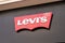 levis brand logo and sign text on fwall acade entrance fashion front store