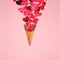 Levitating ice cream cone with splashes of rose petals and hearts. Surprise, holiday and coffee love concept. Minimal art trend.